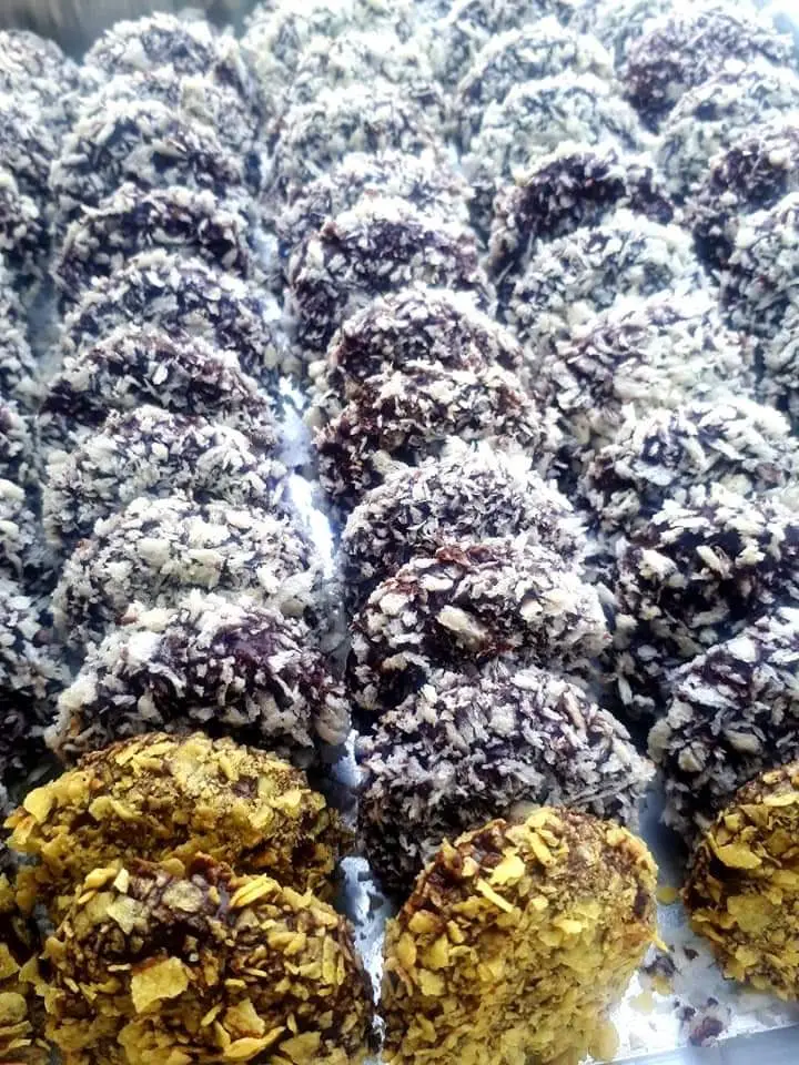 Snow almond cookies coated in chocolate and breadcrumbs on a plate