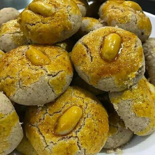 Golden brown coffee peanut cookies arranged on a plate