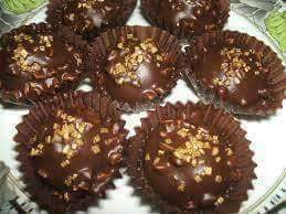 Homemade Ferrero Rocher cookies in paper cups with almond coating
